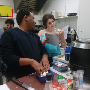 Young people cooking in large kitchen