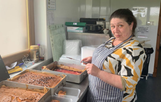 Woman cutting up tray bakes