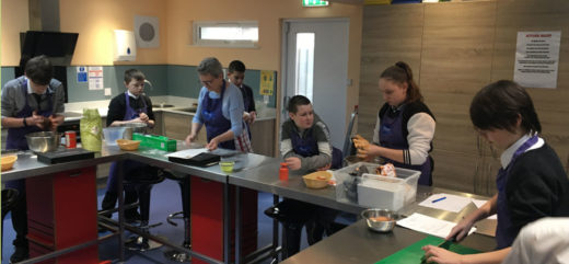 Group of young people cooking in a community kitchen